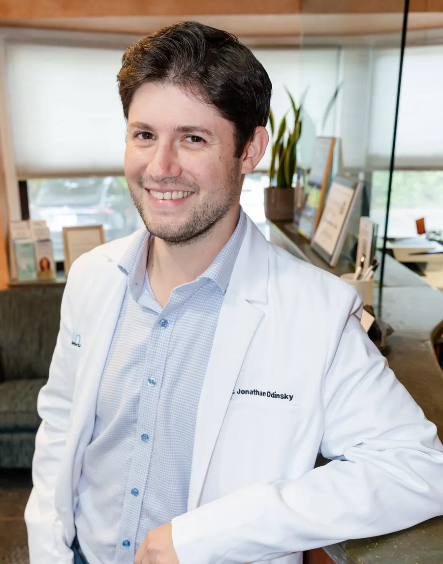 Dr. Jonathan Odinsky at the front desk of Infinity Dental Wellness in Fort Lee, NJ