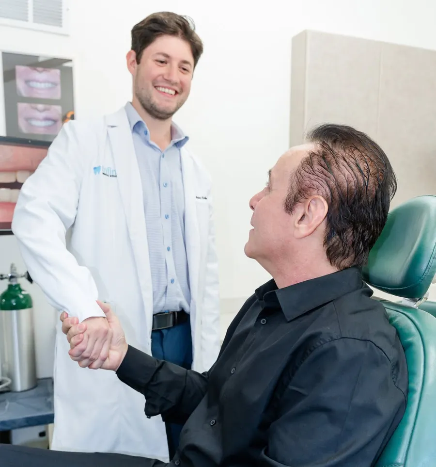Dr. Jonathan Odinsky with a patient at Infinity Dental Wellness in Fort Lee, NJ