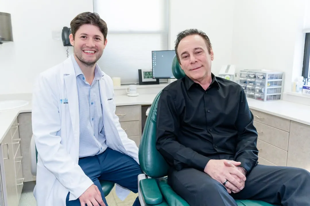 Dr. Jonathan Odinsky with a patient at Infinity Dental Wellness in Fort Lee, NJ